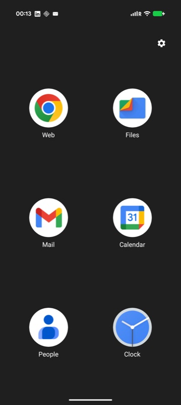 A KAG-built kiosk with a dark background and a sparse 3 by 2 grid of six large app icons and a settings cog.