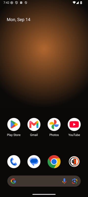 An Android home screen showing the same warm amber wallpaper behind the app launcher, with the generated Bayton Wallpaper app icon in the dock.